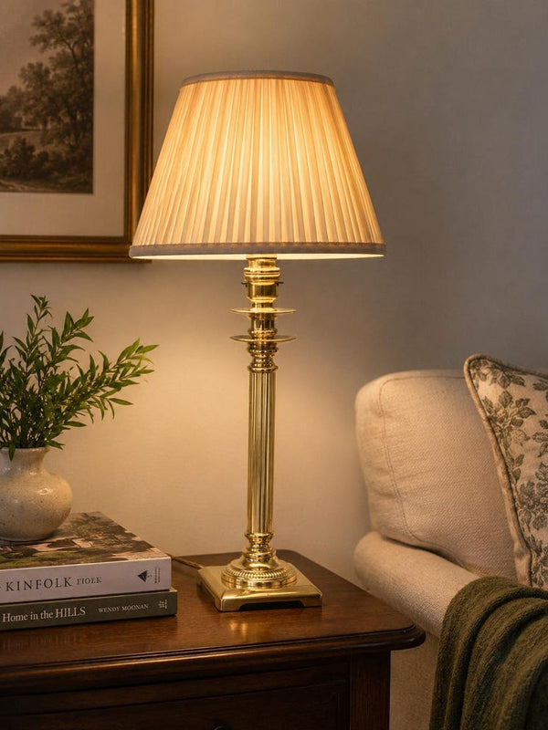 English-made brass column table lamp with fluted stem and neoclassical detailing.