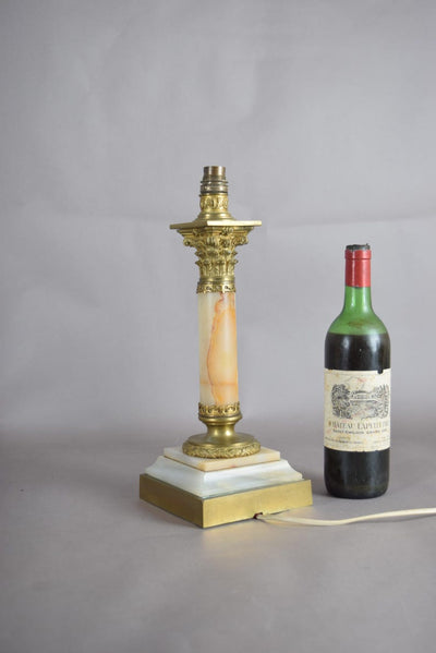 A beautiful early 20th-century table lamp crafted from elegant marble and richly detailed gilt bronze mounts.