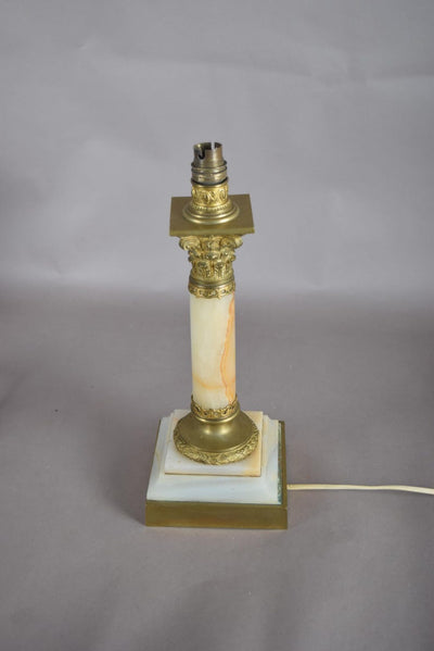A beautiful early 20th-century table lamp crafted from elegant marble and richly detailed gilt bronze mounts.