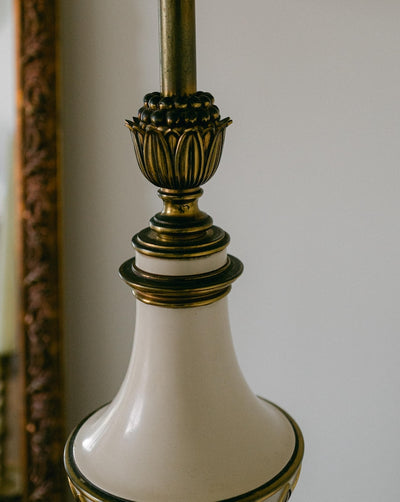 A balanced pair of tall vintage Stiffel porcelain and brass table lamps, styled here in a quiet, symmetrical entryway arrangement