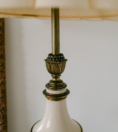 A balanced pair of tall vintage Stiffel porcelain and brass table lamps, styled here in a quiet, symmetrical entryway arrangement