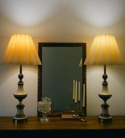 A balanced pair of tall vintage Stiffel porcelain and brass table lamps, styled here in a quiet, symmetrical entryway arrangement