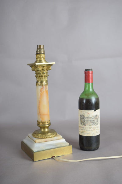 A beautiful early 20th-century table lamp crafted from elegant marble and richly detailed gilt bronze mounts.