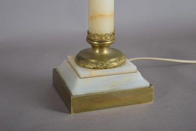 A beautiful early 20th-century table lamp crafted from elegant marble and richly detailed gilt bronze mounts.