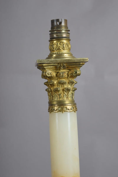 A beautiful early 20th-century table lamp crafted from elegant marble and richly detailed gilt bronze mounts.