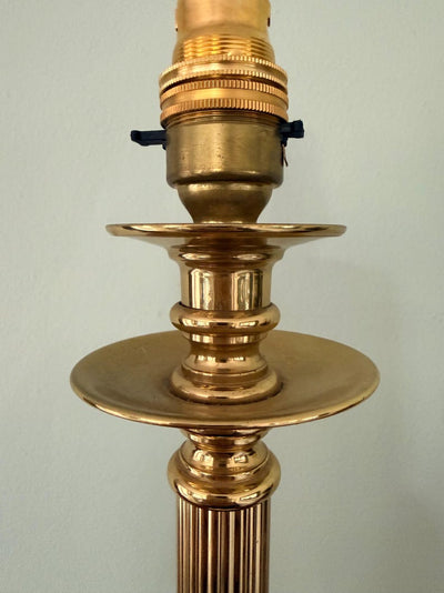 English-made brass column table lamp with fluted stem and neoclassical detailing.