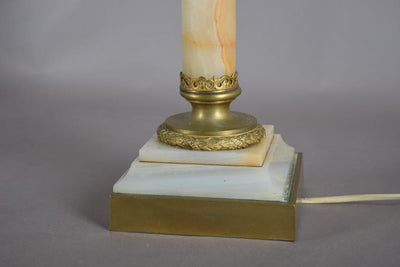 A beautiful early 20th-century table lamp crafted from elegant marble and richly detailed gilt bronze mounts.